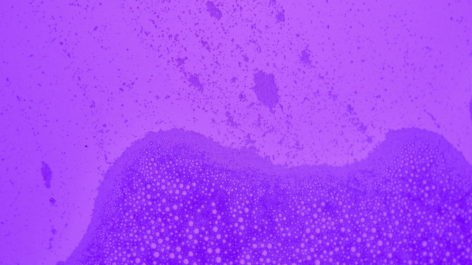 Close-up view of abstract purple bubbles forming a textured background.